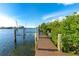 Private wooden dock with boat lifts perfect for enjoying the water at 431 Kettle Harbor Dr, Placida, FL 33946