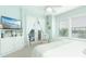 Main bedroom with king bed, balcony access, and built-in entertainment center at 431 Kettle Harbor Dr, Placida, FL 33946