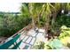 Landscaped backyard with tropical plants and a patio area at 431 Kettle Harbor Dr, Placida, FL 33946