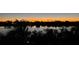 Stunning sunset over calm water with waterfront homes visible in the distance at 431 Kettle Harbor Dr, Placida, FL 33946