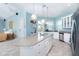 White kitchen with granite island, stainless steel appliances, and light blue walls at 431 Kettle Harbor Dr, Placida, FL 33946