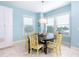 Charming breakfast nook with a round wooden table and yellow chairs at 431 Kettle Harbor Dr, Placida, FL 33946