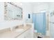 Bathroom with a shower/tub combo and a seashell-themed mirror at 431 Kettle Harbor Dr, Placida, FL 33946