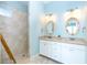 Double vanity bathroom with walk-in shower and shell-decorated mirrors at 431 Kettle Harbor Dr, Placida, FL 33946