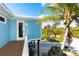 Elevated deck with a view of the home's exterior, landscaping, and a partial view of the driveway and golf cart at 431 Kettle Harbor Dr, Placida, FL 33946
