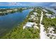 Aerial view of a light blue house by the waterway and ocean at 431 Kettle Harbor Dr, Placida, FL 33946