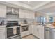 Modern kitchen with stainless steel appliances and white shaker cabinets at 5700 Gulf Shores Dr # B134, Boca Grande, FL 33921