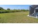 Large backyard with a screened pool and plenty of grassy space at 14207 Union Hall Ave, Port Charlotte, FL 33981