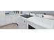 Bright laundry room with white cabinets, granite counters, and modern LG washer and dryer at 14207 Union Hall Ave, Port Charlotte, FL 33981