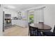 Bright kitchen with modern appliances, white cabinets and an adjacent dining area at 6064 Deming Ave, North Port, FL 34287