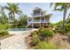 Large backyard with a beautiful pool and lush landscaping at 201 Kettle Harbor Dr, Placida, FL 33946