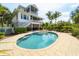 Stunning freeform pool with a sun shelf and tropical landscaping at 201 Kettle Harbor Dr, Placida, FL 33946
