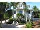 Two story home with lush landscaping and blue door at 201 Kettle Harbor Dr, Placida, FL 33946