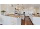 Open kitchen with white cabinets, granite counters, and large island at 201 Kettle Harbor Dr, Placida, FL 33946