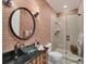 Elegant bathroom with glass shower, dark vanity, and unique wallpaper at 201 Kettle Harbor Dr, Placida, FL 33946