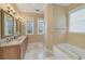 Spa-like bathroom with double vanity, soaking tub, and separate shower at 201 Kettle Harbor Dr, Placida, FL 33946