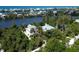 Two waterfront homes nestled amongst lush vegetation at 201 Kettle Harbor Dr, Placida, FL 33946