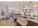 Bright kitchen featuring granite countertops, an island, and white cabinetry at 201 Kettle Harbor Dr, Placida, FL 33946