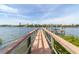 Wooden walkway leads to a private waterfront dock at 201 Kettle Harbor Dr, Placida, FL 33946