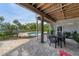 Covered patio with outdoor dining set and views of the pool at 201 Kettle Harbor Dr, Placida, FL 33946