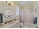 Clean bathroom with white subway tiles, marble vanity, and a bathtub at 201 Kettle Harbor Dr, Placida, FL 33946