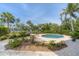 Inviting kidney-shaped pool surrounded by lush landscaping at 201 Kettle Harbor Dr, Placida, FL 33946