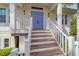 Elevated home with light blue double front doors and white staircase at 201 Kettle Harbor Dr, Placida, FL 33946