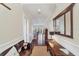 Bright entryway with hardwood floors, bench, and large mirror at 201 Kettle Harbor Dr, Placida, FL 33946