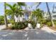 Two-story home with charming front porch and lush landscaping at 201 Kettle Harbor Dr, Placida, FL 33946