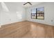 Bright bedroom featuring hardwood floors, a ceiling fan, and a window providing natural light at 104 Park Forest Blvd, Englewood, FL 34223