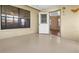 Cozy, well-lit Florida room with painted floor and access to a door at 104 Park Forest Blvd, Englewood, FL 34223