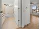 Hallway and bathroom featuring hardwood floors, a shower, and a toilet at 104 Park Forest Blvd, Englewood, FL 34223