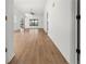 Bright living room featuring sleek, wood-look flooring and a ceiling fan at 104 Park Forest Blvd, Englewood, FL 34223