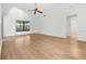 Living room with vaulted ceilings and sleek, wood-look flooring at 104 Park Forest Blvd, Englewood, FL 34223