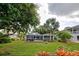 Large backyard with screened patio and lush landscaping at 110 S Oxford Dr, Englewood, FL 34223