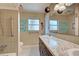 Bathroom boasts double sinks, updated vanity, and a shower/tub combo at 110 S Oxford Dr, Englewood, FL 34223