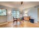 Bright dining area with wood flooring and a mid-century modern vibe at 110 S Oxford Dr, Englewood, FL 34223