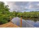 Wooden dock offers scenic views of the water at 110 S Oxford Dr, Englewood, FL 34223