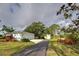 Long driveway leading to a two-car garage and detached garage at 110 S Oxford Dr, Englewood, FL 34223