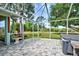 Relax in this screened-in hot tub with paver patio and lush landscaping at 110 S Oxford Dr, Englewood, FL 34223