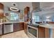 Open concept kitchen with island and stainless steel appliances at 110 S Oxford Dr, Englewood, FL 34223
