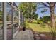 Spacious screened patio overlooking a lush green backyard at 110 S Oxford Dr, Englewood, FL 34223