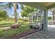 Relaxing screened porch overlooking a lush backyard at 110 S Oxford Dr, Englewood, FL 34223