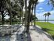 Relaxing waterfront picnic area with stone table and benches at 4691 Club Dr # 102, Port Charlotte, FL 33953