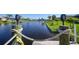 View from dock of canal with lush landscaping at 9194 Impala Cir, Port Charlotte, FL 33981