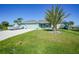 Single-story house with two-car garage and lush lawn at 9194 Impala Cir, Port Charlotte, FL 33981