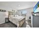 King-size bed, TV, dresser, and calming decor at 9194 Impala Cir, Port Charlotte, FL 33981