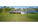 Private dock with seating area and shade sail, perfect for relaxing by the water at 9194 Impala Cir, Port Charlotte, FL 33981