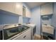 Laundry room with washer, dryer, cabinets, and utility sink at 9194 Impala Cir, Port Charlotte, FL 33981