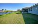 Landscaped backyard with canal views and access to the home at 9194 Impala Cir, Port Charlotte, FL 33981